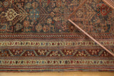 Antique Qashqai rug: geometric border and dense madder red and blue field.
