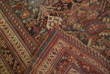 Hand-knotted Qashqai rug corner showing intricate borders, germinating plants, and pinwheels.