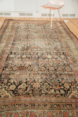 Angled view of the antique runner's Herati pattern, showing even pile wear and softened hues.