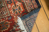 Vintage Mahal rug corner, revealing intricate Herati motif, fringe, and hand-knotted foundation.