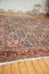 Fringed edge and intricate rust border of vintage Mahal rug with navy Herati pattern.