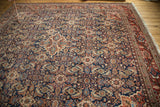 Intricate Herati motif with rust, navy, and beige tones on the hand-knotted Mahal rug surface.