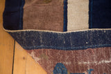 Visible hand-knotted foundation and cobalt blue, mauve pile of a Peking carpet.