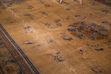 Vintage Peking carpet border: dark navy Greek key and stylized motifs on worn ivory field.