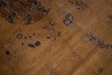 Close-up of vintage Peking carpet pile, showing worn tea brown field, early deco motifs and white knots.