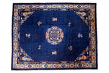 Vintage Peking rug, central floral medallion, sparse ornamentation, cobalt blue field.