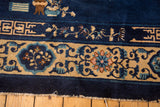 Vintage Peking carpet border, with pale gold, blush floral motifs, and indigo curvilinear designs.