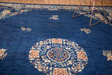 Vintage Peking carpet with scalloped medallion, ivory, blush, gold floral motifs on cobalt field.