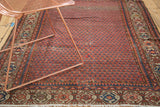 Vintage Hamadan rug's madder red field, allover mir design, rich abrash, and localized distress.