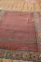 Vintage Hamadan rug's madder red mir design, abrash striations, and geometric navy blue border.