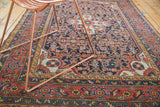 Vintage Dargezine rug close-up showing expressive ivory medallion and navy blue Herati field.