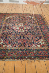 Vintage Dargezine rug corner showcasing lattice, Herati motifs, brick red border, and secure fringe.