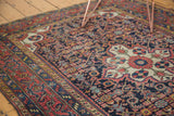 Vintage Dargezine rug detail showing primitive blossoming floral patterns and intricate Herati motifs on navy field.