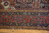 Vintage Dargezine rug's detailed borders with brick red, navy, yellow, and blush motifs.