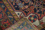 Folded corner of vintage Dargezine rug, revealing its colorful pile and hand-woven beige foundation.