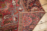 Folded corner of vintage Mehrivan carpet reveals geometric pile, wear, and hand-knotted foundation.