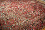 Angled view of vintage Mehrivan carpet pattern with geometric florals, cherry red, ivory, and visible wear.