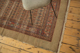 Corner of vintage Hamadan runner, showing madder red floral field and tattered camel hair border.