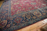 Antique Yezd carpet featuring intricate palmette and tendril patterns in cochineal red and navy.