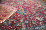Antique Yezd carpet with intricate cochineal red field, blue palmettes, and aged distress.
