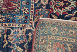 Distressed front of Antique Yezd carpet with intricate navy, red, teal patterns and visible woven reverse.