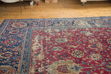 Cochineal red antique Yezd rug, sprawling palmettes, tendrils, distressed navy border.