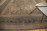 Vintage Persian Meshed rug section with distressed ivory, navy, and wine red floral border.