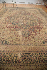 Vintage Persian Meshed carpet border, ornate navy and red floral design, time-softened ivory.
