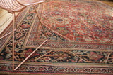 Cherry red field of Vintage Mahalati carpet with inverted Herati motifs and charcoal navy border.