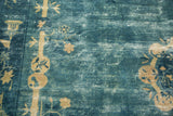 Pale ivory stylized florals and Tao symbolism on a time-softened watery blue antique Peking rug.