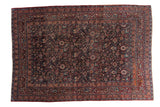 Distressed vintage Meshed carpet, allover floral vines in plum, peach, blue on dark field.
