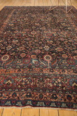 Vintage Meshed carpet border with plum, peach, burgundy floral vines, distressed pile, and fringe.