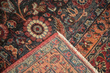 Vintage Persian Meshed rug showing intricate distressed floral pile, geometric woven back, and fringe.