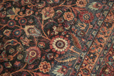Distressed floral vines and border detail on a vintage Persian Meshed rug.