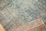 Distressed Persian Mahal carpet texture with faded aqua blue and cinnamon Herati motifs.