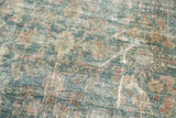 Textural detail of the vintage Mahal rug's distressed aesthetic, showing faded aqua and red.