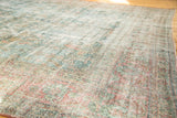 Distressed texture of vintage Mahal carpet with faded aqua blue and cinnamon red.