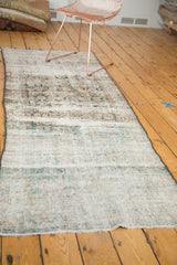 Distressed Mahal runner end with exposed foundation, revealing faded blue, blush, and ivory tones.