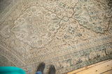 Distressed Northwest Persian rug with worn pile, visible foundation, ivory, apricot, and muted charcoal patterns.