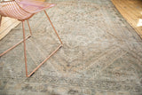 Distressed Northwest Persian rug corner, worn pile, visible foundation, antique ivory tones.