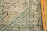 Distressed Northwest Persian carpet showing worn pale apricot and teal geometric patterns.