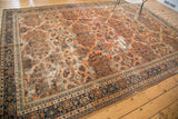 Vintage Mahal carpet corner, showing terra cotta field with scrolling vinery and multi-toned borders.