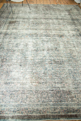 Textured distress on vintage Meshed carpet, foundation threads showing, with faded blue and peach colors.