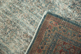 Distressed Meshed carpet showing worn denim blue pile, exposed foundation, and burgundy floral border.