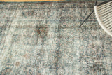 Distressed vintage Meshed carpet pile showing foundation with denim blue, peach, and red tones.