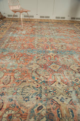 Antique Sultanabad carpet featuring sprawling pale terracotta and sky blue motifs with natural wear.