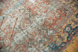 Antique Sultanabad corner showcasing navy border and faded terra cotta floral patterns.