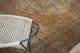 Distressed texture and aged patina of antique Tabriz carpet with faded apricot and blue motifs.