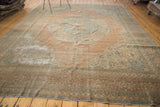 Distressed antique Jalili Tabriz carpet with muted apricot field and faded sky blue medallion.