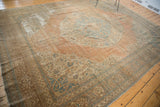 Patina and distressed texture on an antique Tabriz rug's curvilinear floral corner.